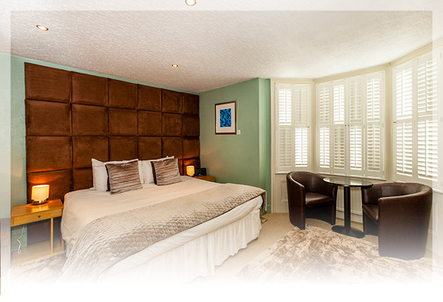Modern super-king or twin beds, with stylish over-sized suede headboard